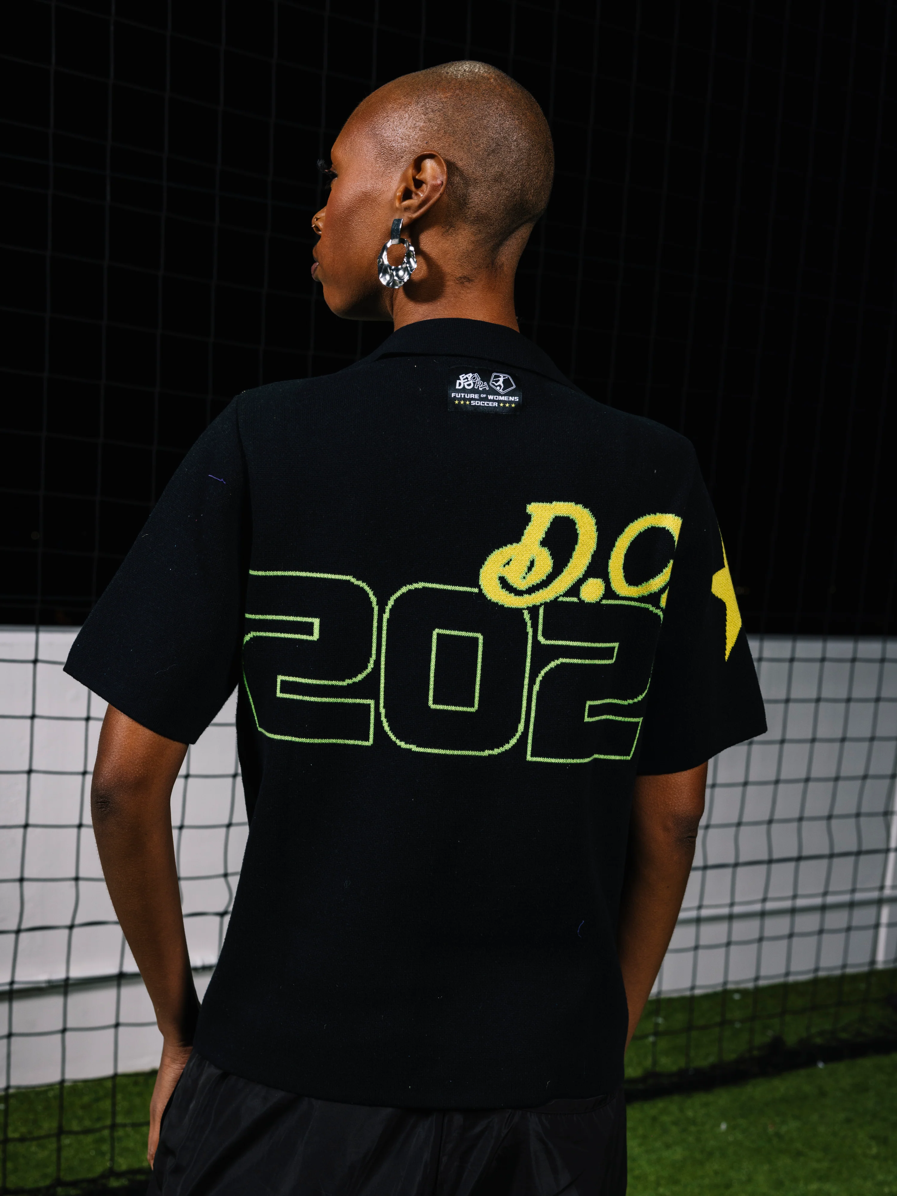Model wearing the Washington Spirit X Dead Dirt NWSL Knit Polo, back view