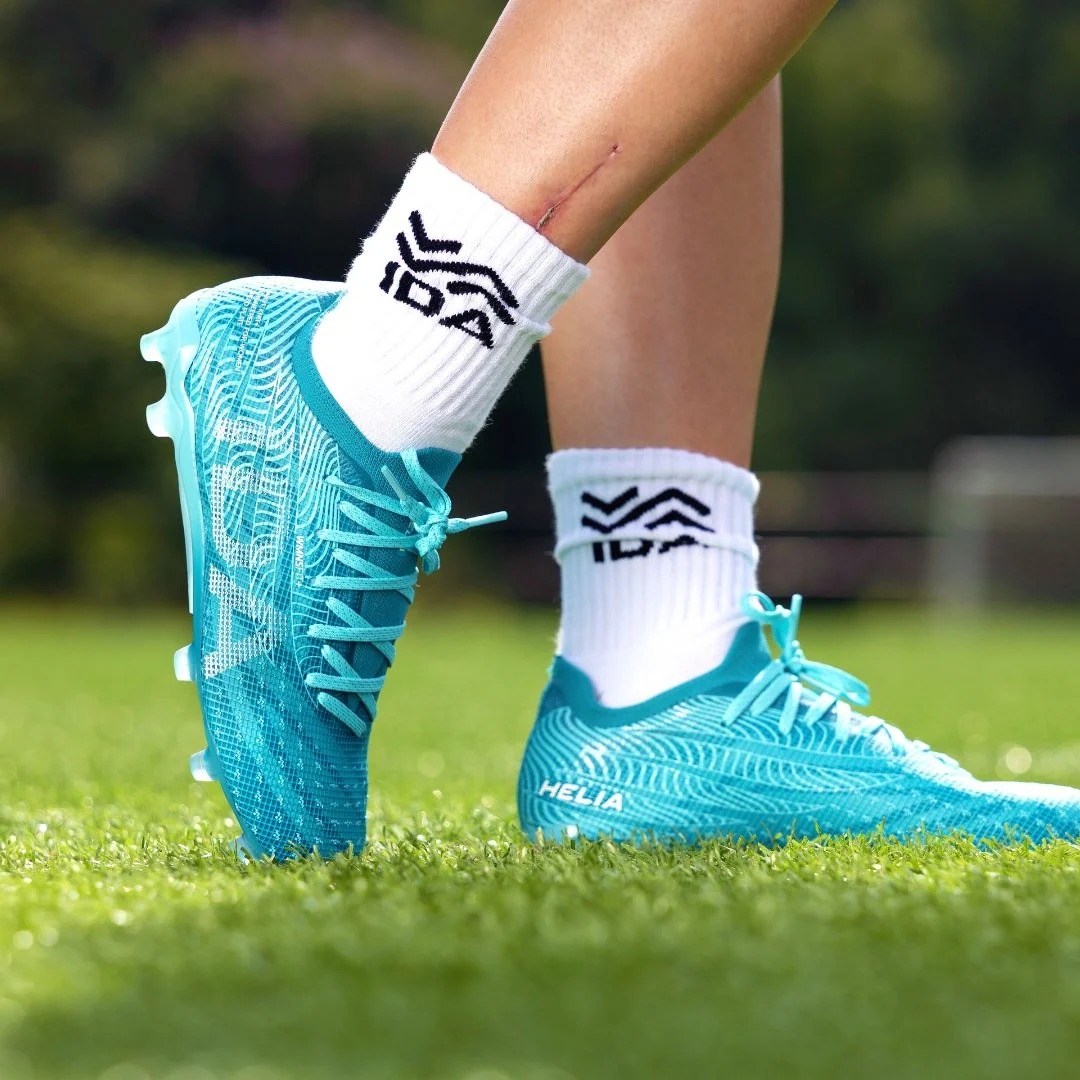 IDA Helia Elite FG/AG Blue soccer cleats, on-field lifestyle view