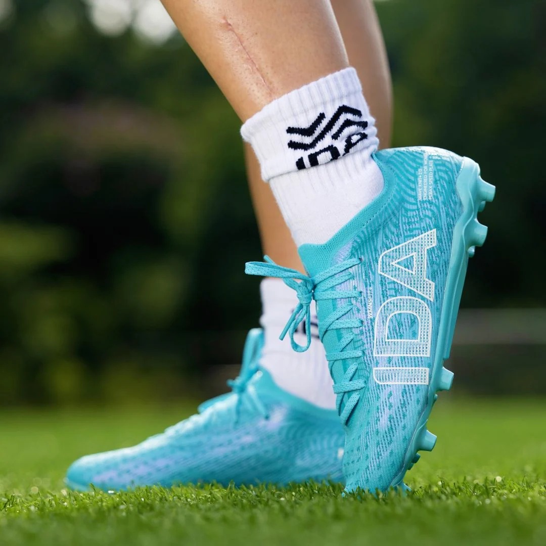IDA Helia Pro FG/AG Blue soccer cleats, on-field lifestyle view