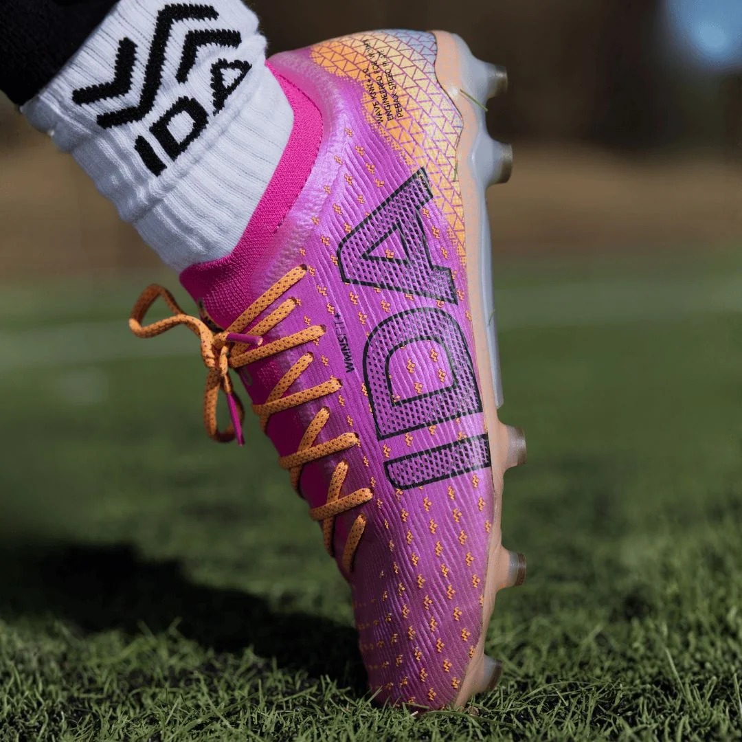 IDA Helia Pro FG/AG Dark Pink soccer cleats, on-grass lifestyle view